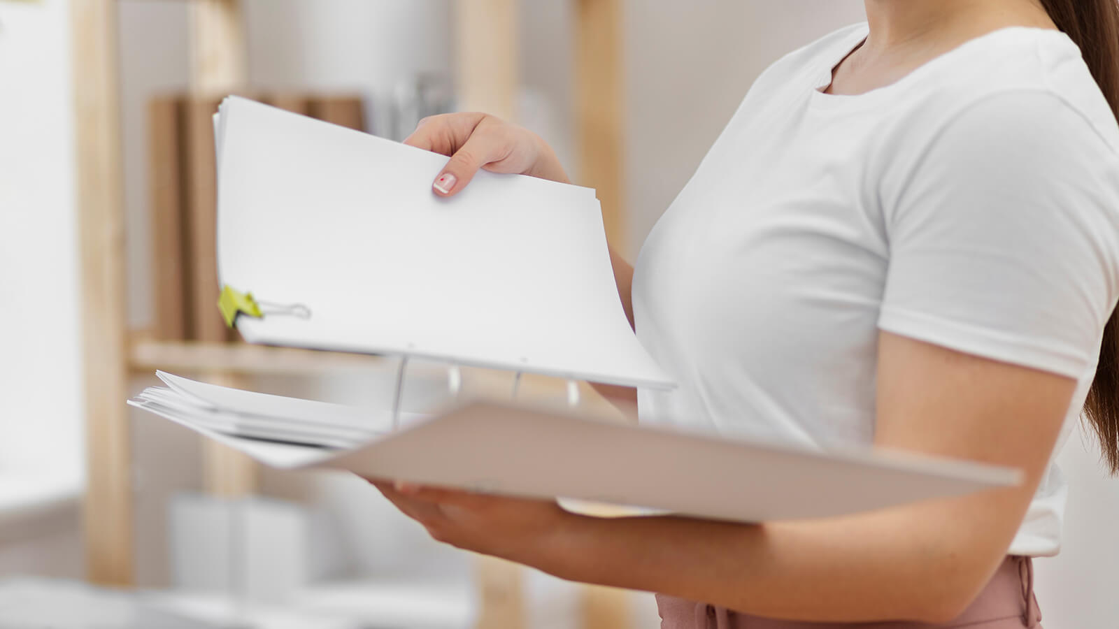 person holding a paper file