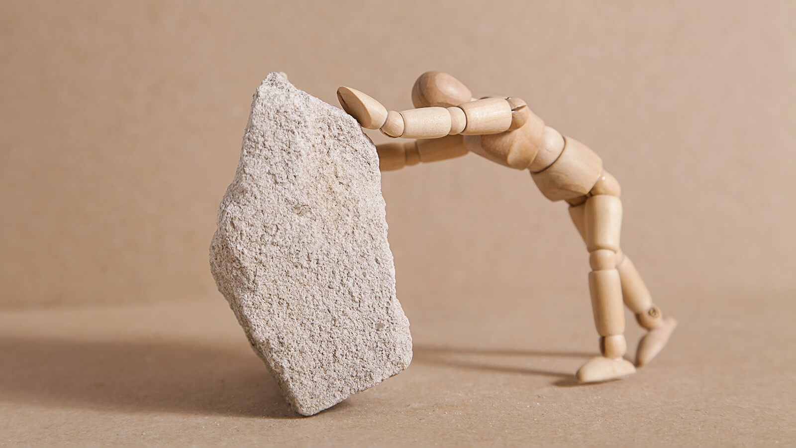 mannequin pushing a stone